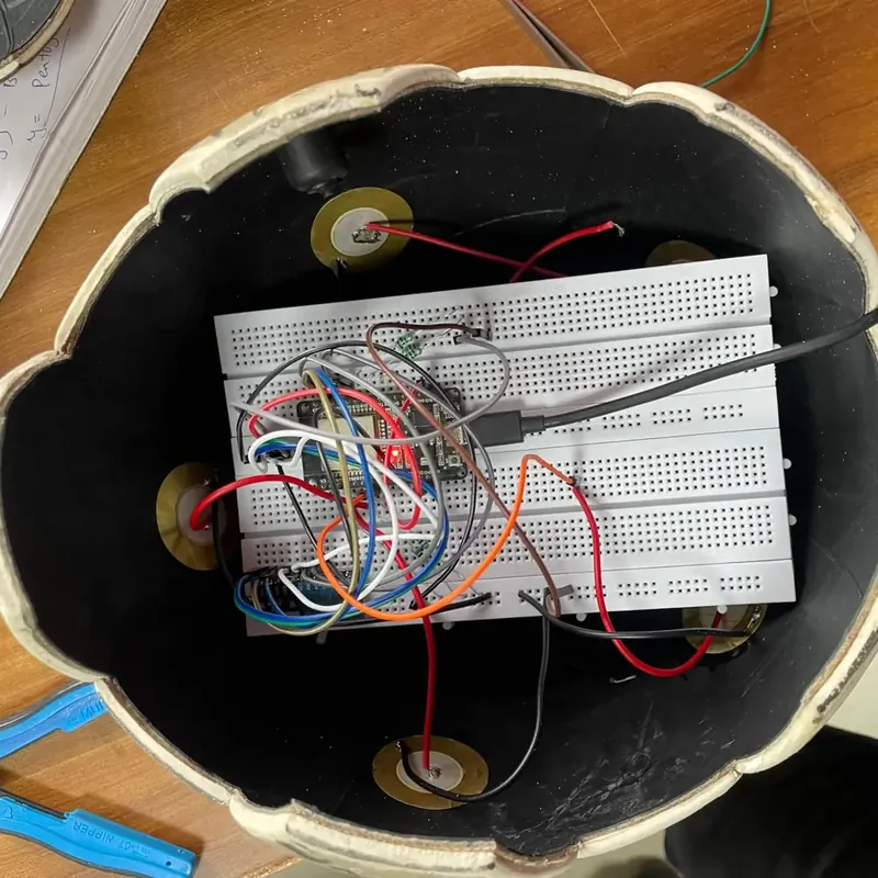 The first Smart Football prototype: an open football shell with piezo sensors and a breadboard of wires inside