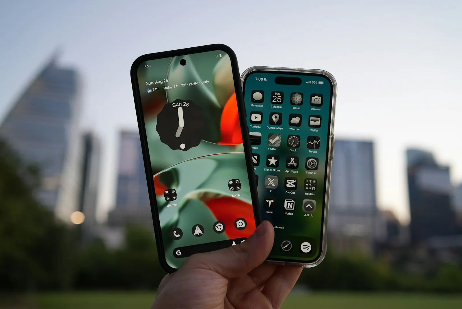 Two smartphones held up against a city skyline, one Android and one iPhone