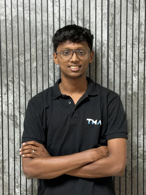 Rahul Dhileep Kumar, founder of Track My Academy, in a black TMA polo with arms crossed
